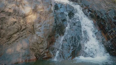 Waterfall Flowing Through Pass Texture of Rock Nook to Pond Stock Footage 154017019