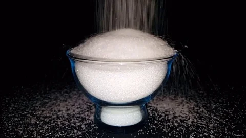 A waterfall flowing like white sugar on black background Stock Footage 83876936