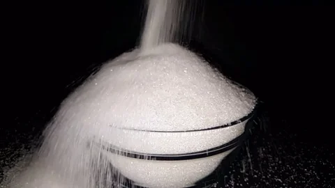 A waterfall flowing like white sugar on black background Stock Footage 83876973