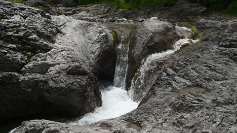 Waterfall flows between rocks from a mountain stream Stock-Footage 211459305