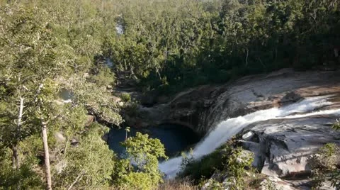 Waterfall flows into deep pool Stock Footage 11235778