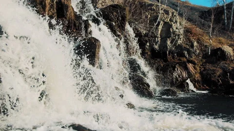 Waterfall flows down in autumn Stock Footage 168276472