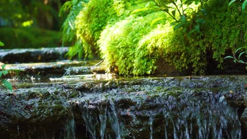A waterfall that flows gently down the rocks. Stock Footage 275568928