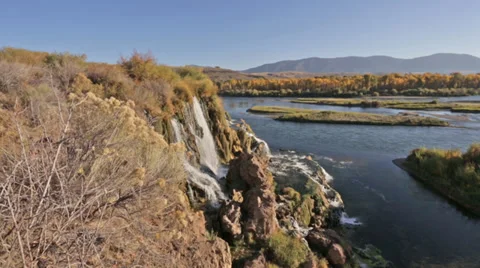 A waterfall flows into an Idaho river Stock Footage 36321172