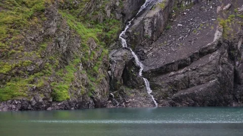 The waterfall flows into a mountain lake Stock-Footage 85391800