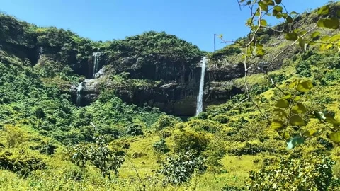 This waterfall flows over layered basalt rock formations Stock Footage 340267744