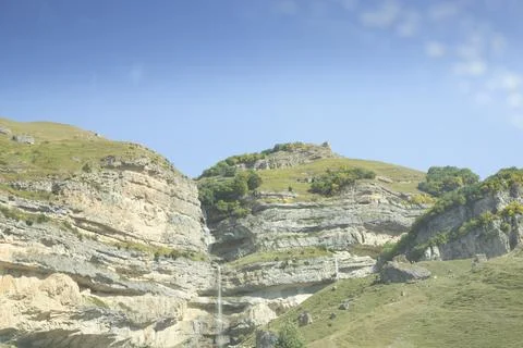 The waterfall flows over the rocks Stock Photos