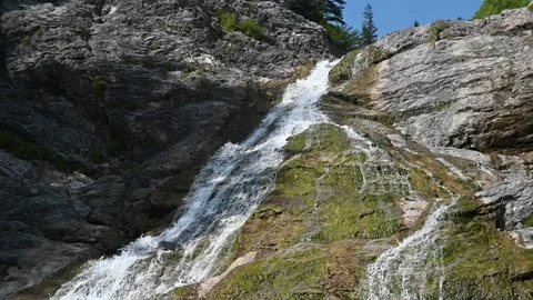 A waterfall flows over rocks into a pool (slow motion) Stock-Footage 219645000