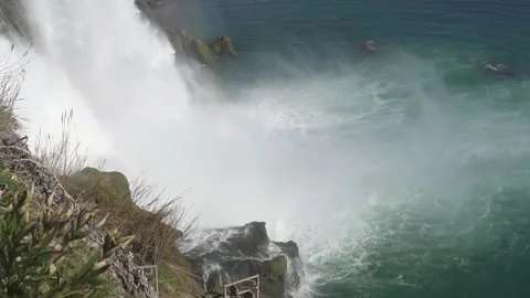 The waterfall flows into the sea, cloud and fog. Video stock 169161928