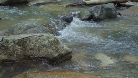 The waterfall flows through the layers of rocks. Stock Footage 240534378
