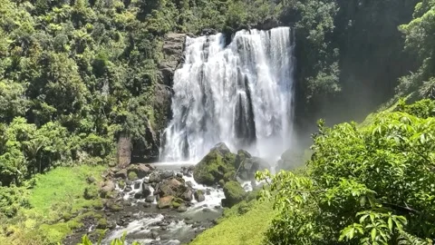 This waterfall flows through lush limestone countryside Stock Footage 340267586