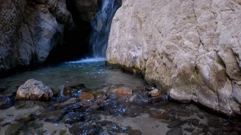 A waterfall that flows through the mountains Stock Footage 171532705
