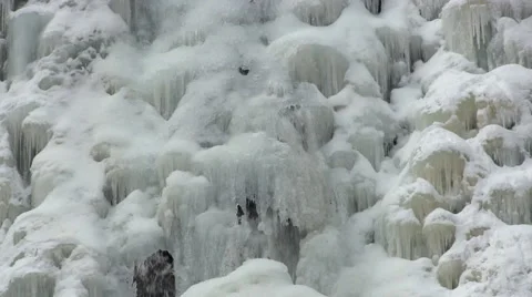 Waterfall flows under ice Stock Footage 49648116