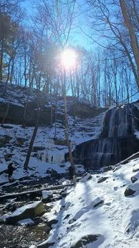Waterfall flows in winter at Ohio park. Stock Photos