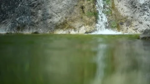 Waterfall flushing into a natural pool with green water (slow motion) Stock-Footage 211763454