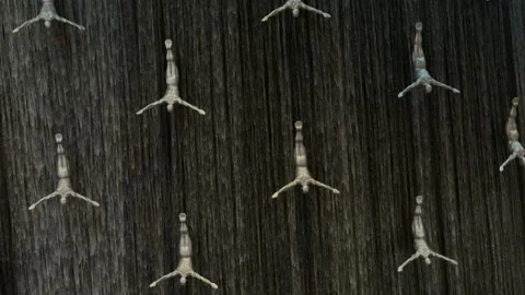 Waterfall with Flying Diving Men inside Dubai Mall. Stock Footage 154163498