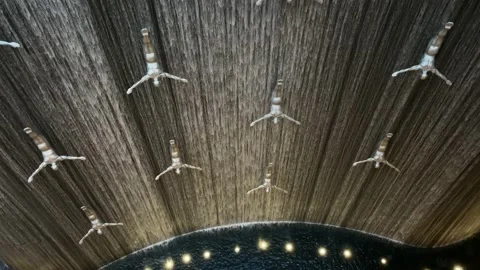 Waterfall with Flying Diving Men inside Dubai Mall. Stock Footage 154163572