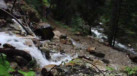 Waterfall in Forest and mountain biker Stock Footage 23568948