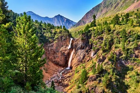 Waterfall in forest border in mountains Stock Photos