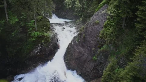 Waterfall in the forest flows down the rocks. Wild nature. Summer. Slow motion Stockbeeldmateriaal 204762286