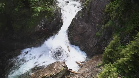 Waterfall in the forest flows down the rocks. Wild nature. Summer. Slow motion Stockbeeldmateriaal 204762292