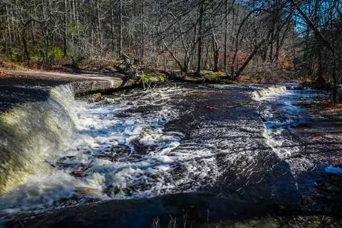 A waterfall in a forest Stock Photos