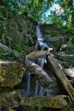 A waterfall in a forest Stock Photos