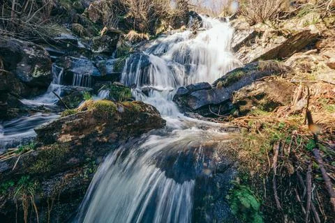 A waterfall in a forest Stock Photos