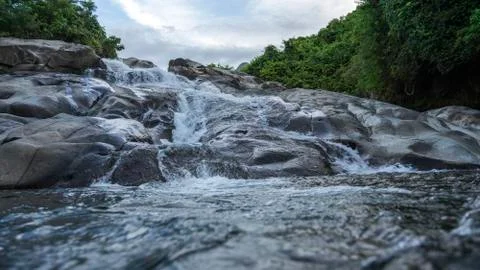 A waterfall that formed from a mountain river. Stock Photos