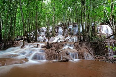 Waterfall in green forest Stock Photos