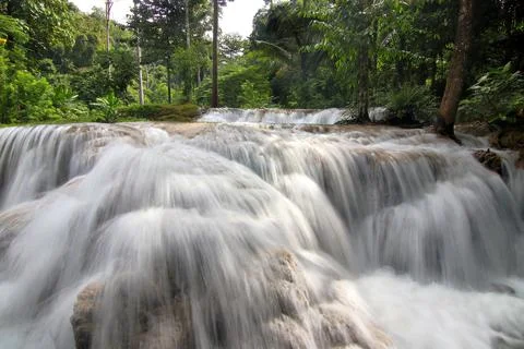 Waterfall in green forest Stock Photos