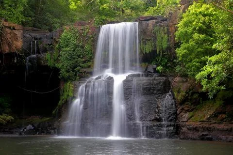 Waterfall in green forest Stock Photos