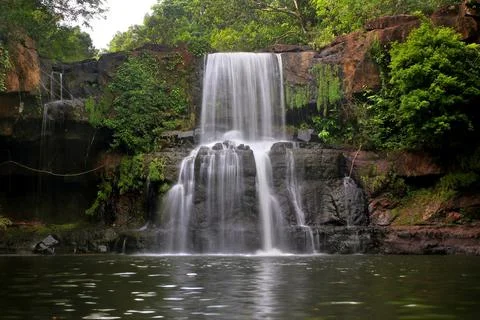 Waterfall in green forest Stock Photos