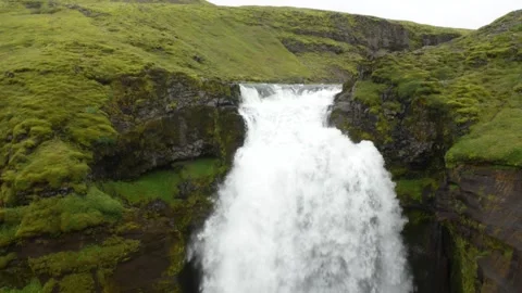 Waterfall in green grass and mossed stones during hiking in Skogafoss, Iceland Stock Footage 247513075