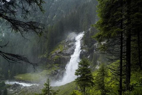 Waterfall in green pine forest Stock Photos