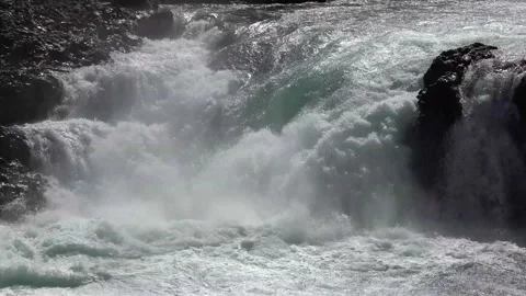 Waterfall with green water falling between lava flow 3 Stock Footage 136892357