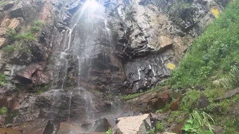 Waterfall high in the mountains, water fall from the rocky mountains. Stock Footage 132952460