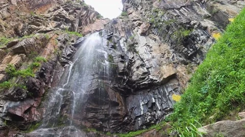 Waterfall high in the mountains, water fall from the rocky mountains. Stock Footage 132952497