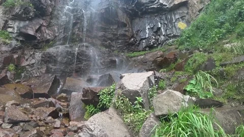Waterfall high in the mountains, water fall from the rocky mountains. Stock Footage 132952521