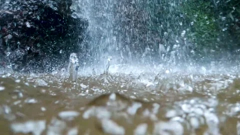 Waterfall hits surface with rock and muddy background normal speed Stock Footage 152442920