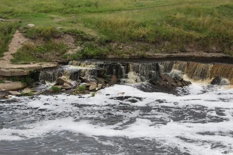 Waterfall with a huge current, mountain waterfall. Stock Photos