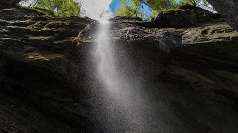 A waterfall inside a gorge Stock Photos