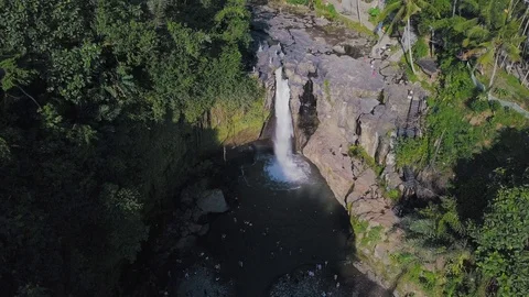 Waterfall in the jungle under the sun light aerial footage camera flight around Stock Footage 100654744
