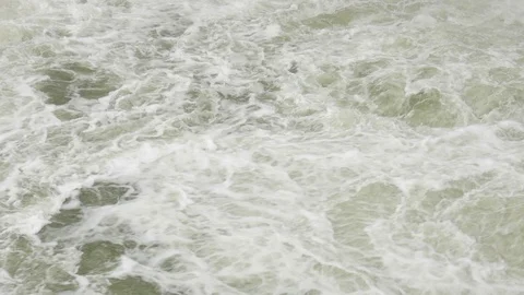 Waterfall. A large stream of water flows from the dam and boils Stock Footage 121480250