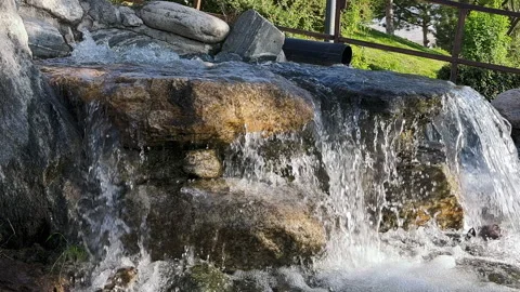 Waterfall LeftClose-up view of a small artificial stone waterfall Stock Footage 256158404