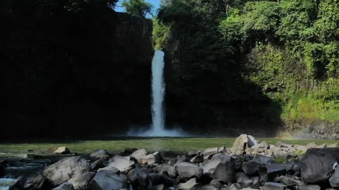 Waterfall Lontar has a height of 35 meters and is a source of hydropower power Stock Footage 147428577
