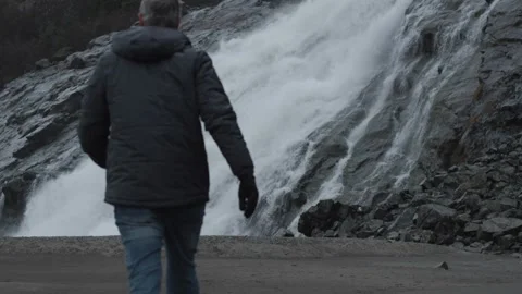 Waterfall with Man Walking in Slow Motion Stock Footage 245572572