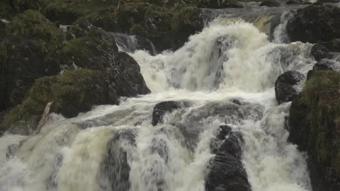 Waterfall. Medium shot of water flowing over rocks in slow motion Stock Footage 86830936
