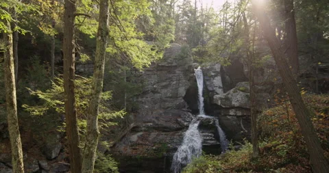 A waterfall in the middle of forest in a sunny day Stock-Footage 144983653