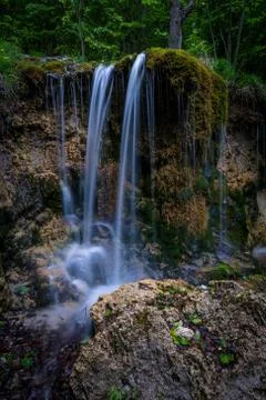 Waterfall in the middle of the mountains Stock Photos